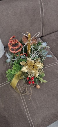 An elegant table centerpiece with glowing candles surrounded by seasonal botanicals.