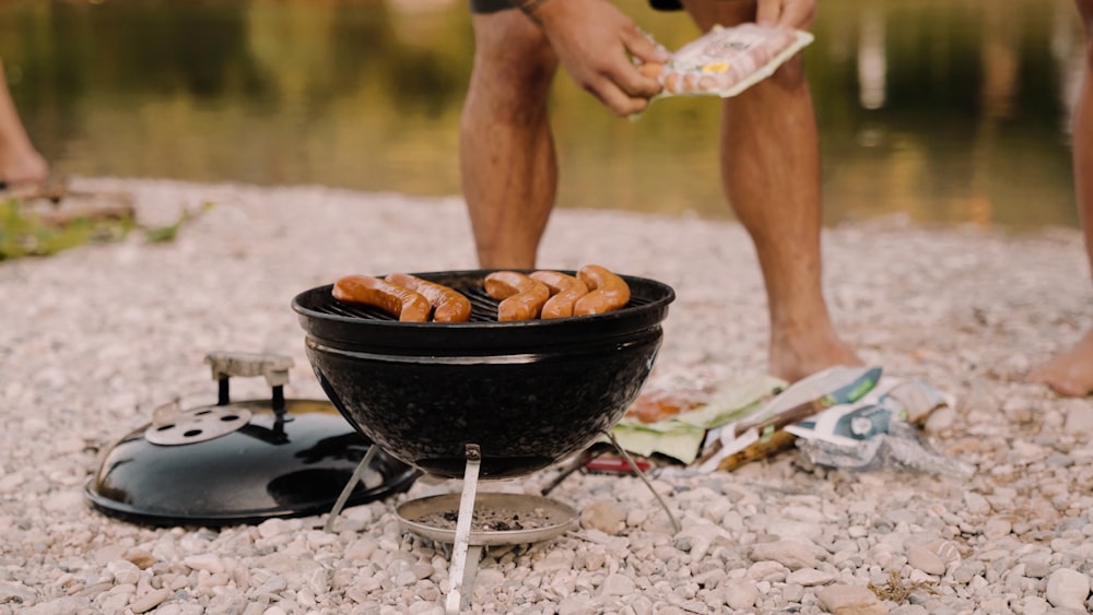 a person cooking food on a grill