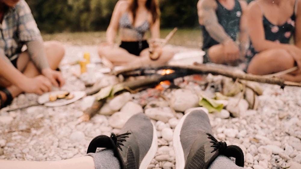 a group of people sitting around a fire pit