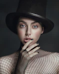a person wearing a hat and smoking a cigarette
