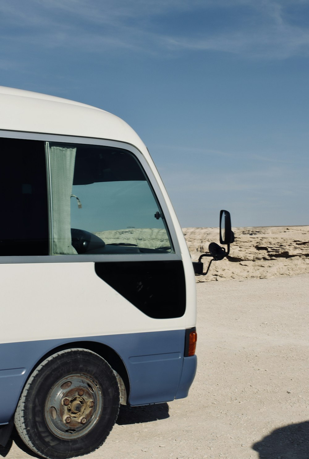 a white van parked on a sandy beach