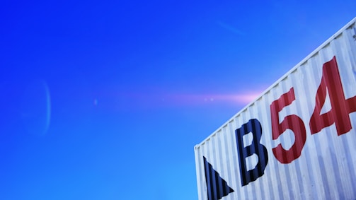 A 40-foot solar cooling container set up at a commercial site with clear blue sky.