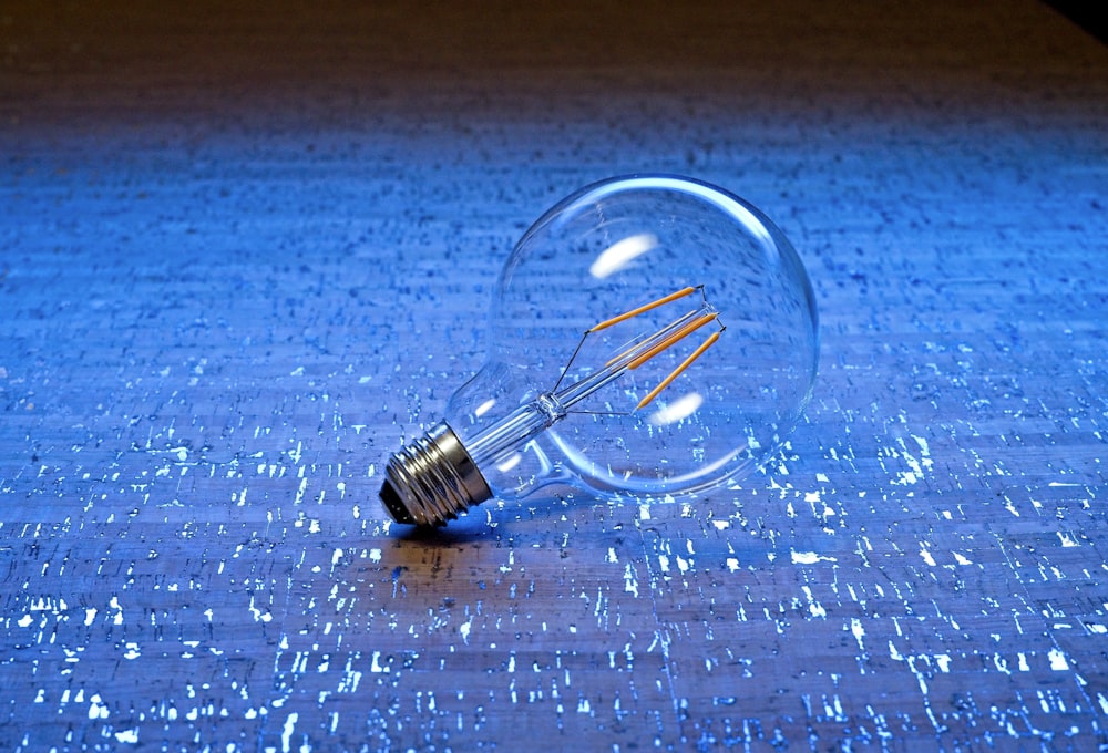 a small metal object on a blue surface