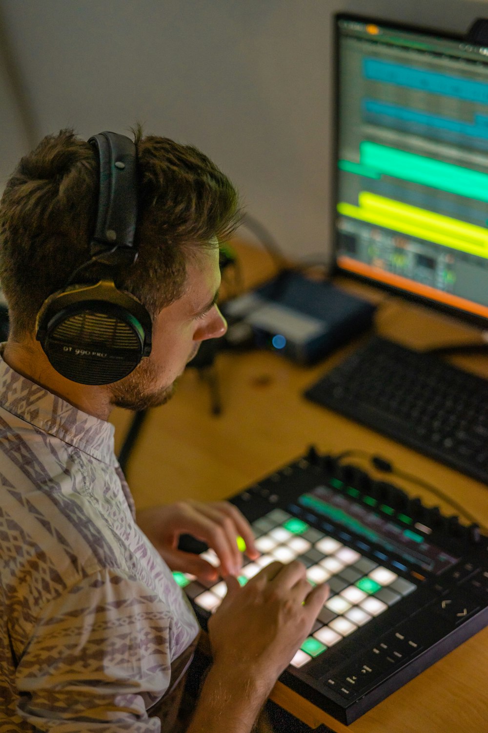 a man wearing headphones and playing a computer game