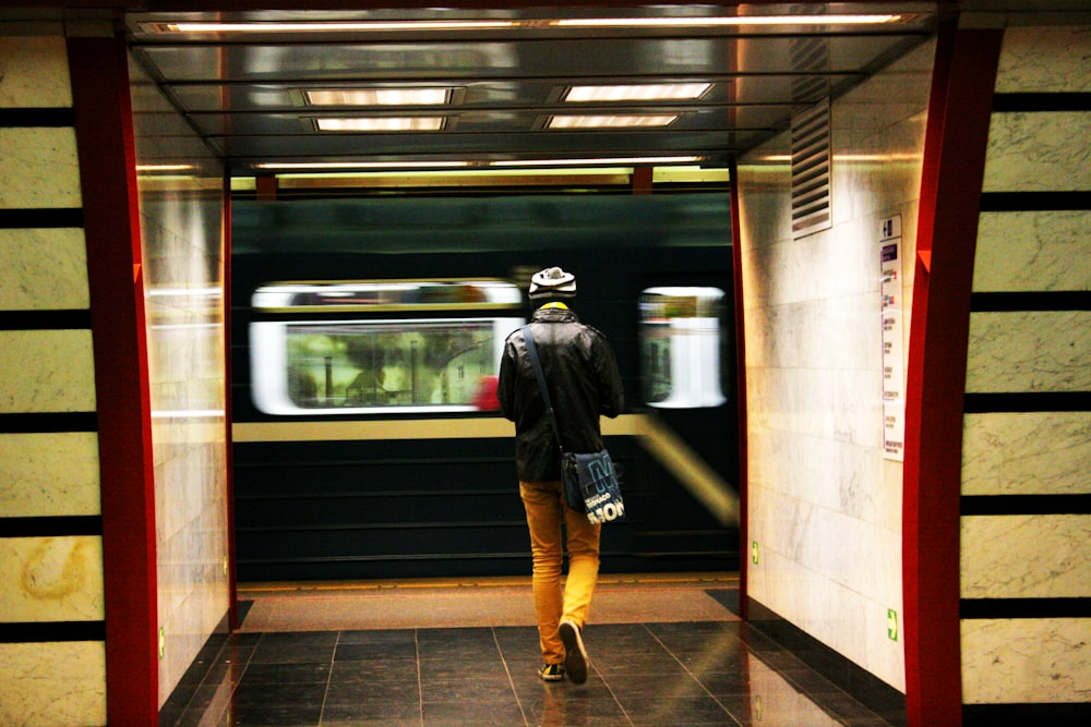 a man walking out of a subway