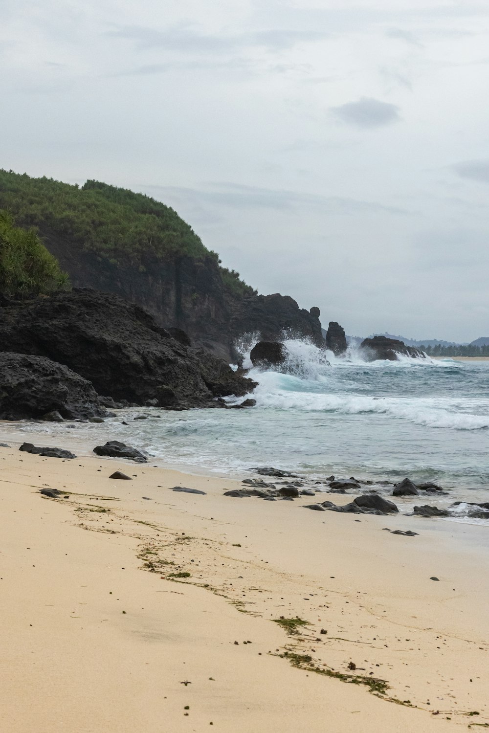 a beach with waves crashing on it