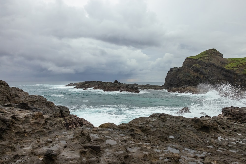 a rocky beach with waves crashing on it