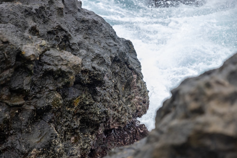 a rocky cliff next to the ocean