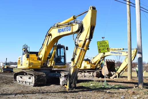 a yellow bulldozer in a dirt field