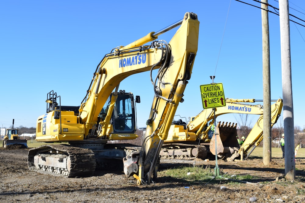 a yellow bulldozer in a dirt field