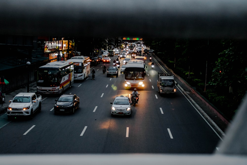 a group of vehicles travel down a street