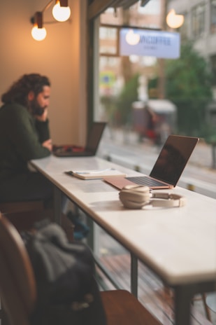 a person sitting at a table with a laptop