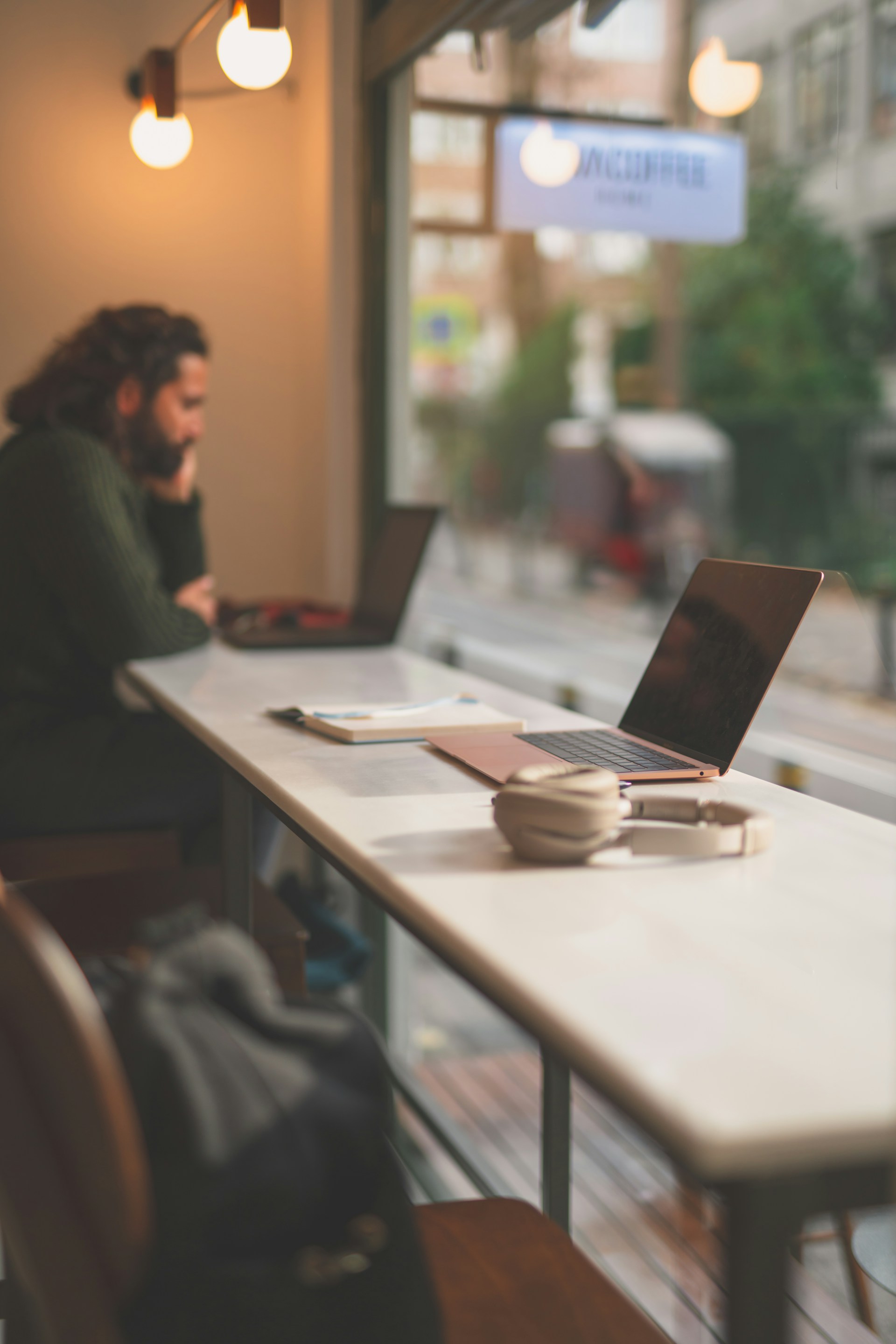 a person sitting at a table with a laptop