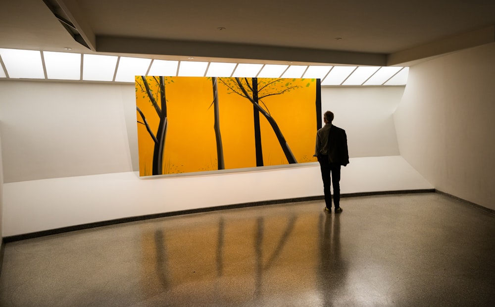 a person standing in front of a painting