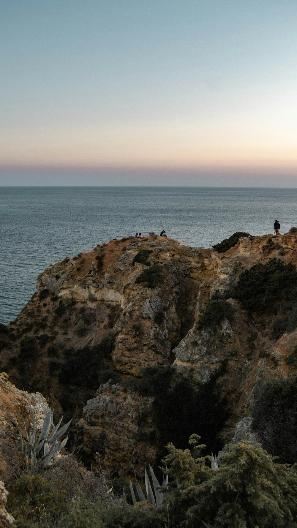 a cliff with a body of water below