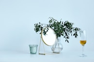 A minimalist arrangement of gold and violet decorative objects on a wooden surface.