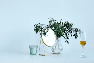 Minimalist gold-accented vases and table decorations on a white marble surface.