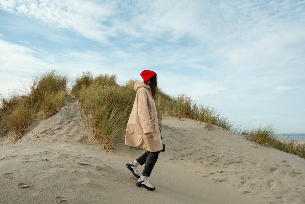 a man walking on a sandy beach