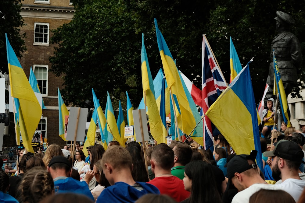 a crowd of people holding flags