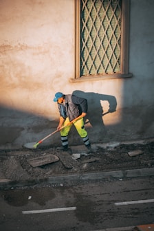 Annick Building Services service and maintenance contracts, a person sweeping the street