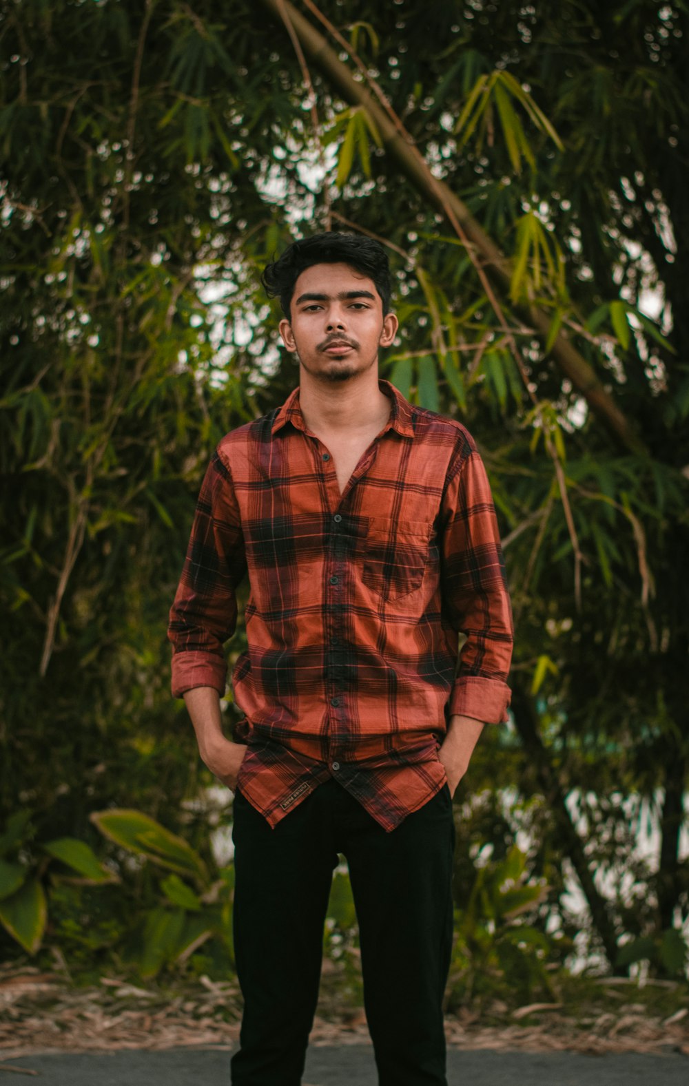 a man standing in front of a tree