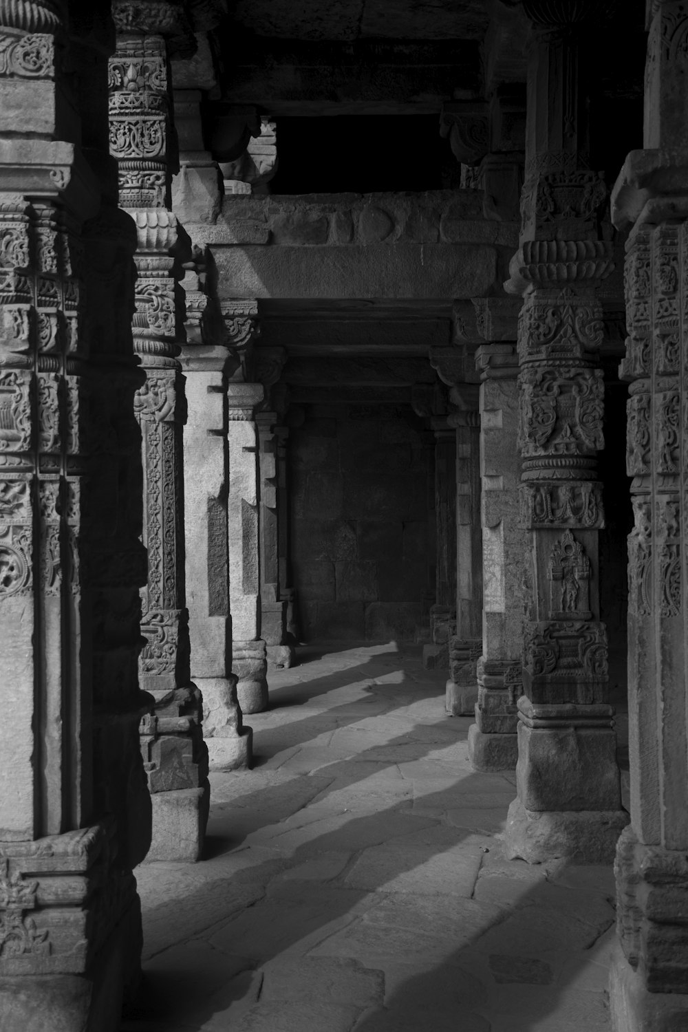 a stone walkway with pillars