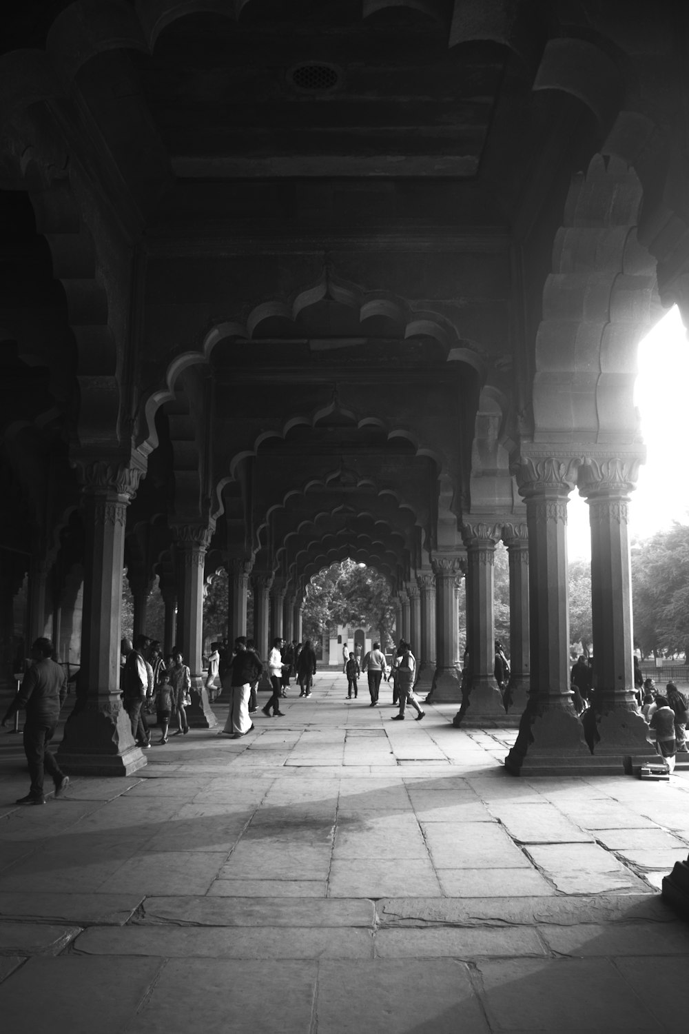 a group of people walking under a bridge