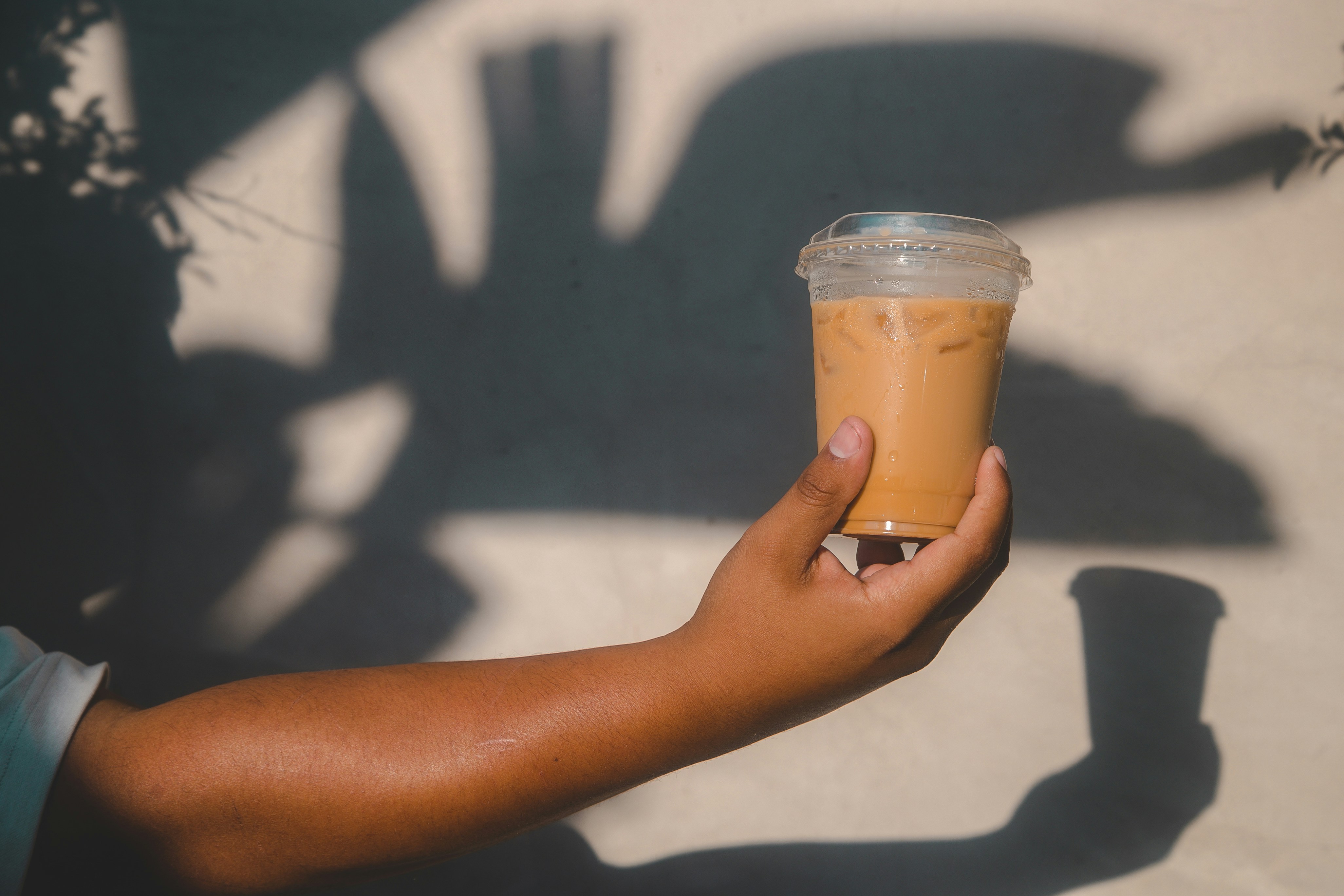 a person holding a glass of beer