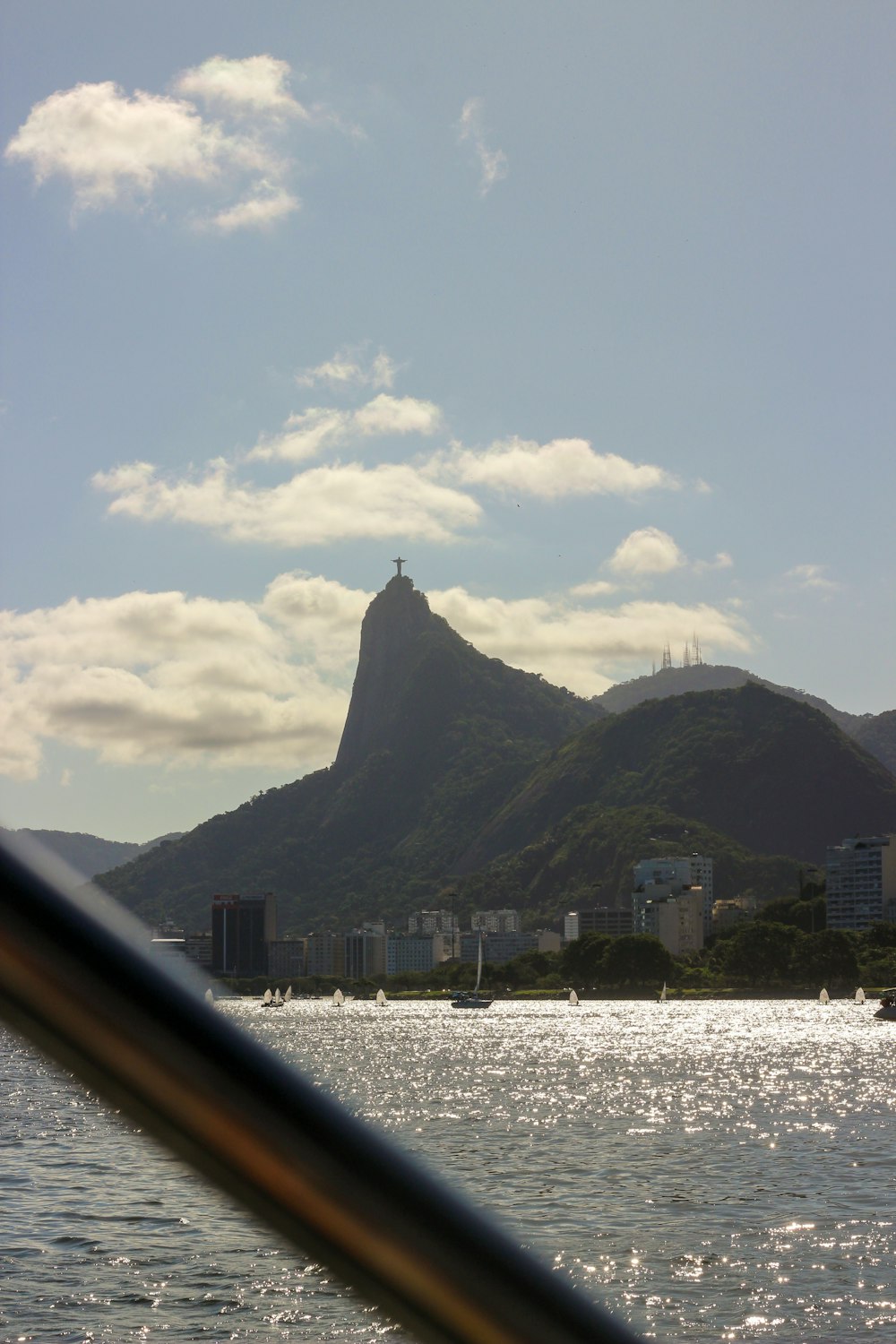 a city next to a body of water with a mountain in the background