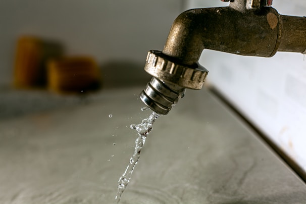 a water droplet pouring water into a faucet