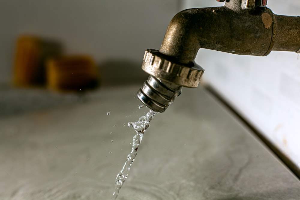 a water droplet pouring water into a faucet