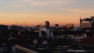 Rooftop view of Binghatti residences overlooking the city skyline at sunset.