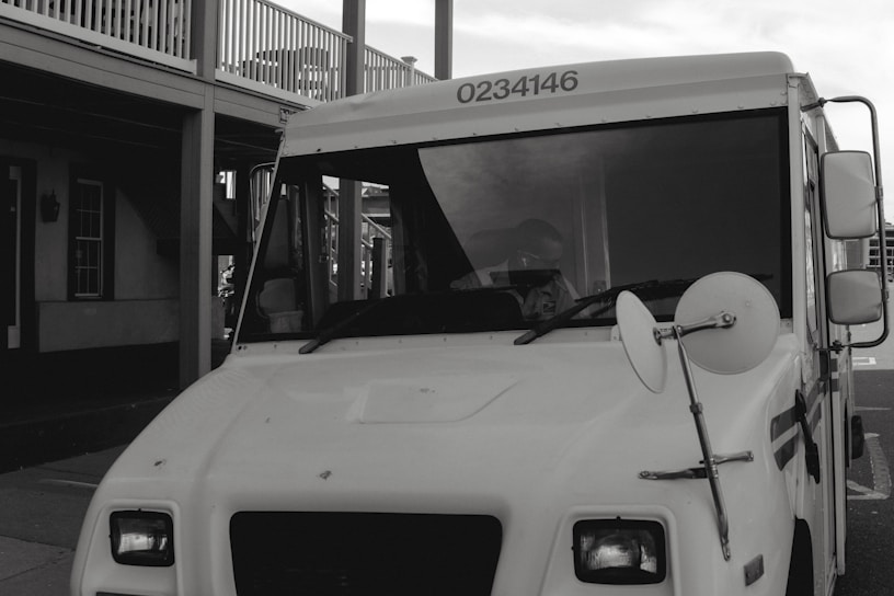 A delivery truck with Tex Coat Roofing branding arriving at a customer's home