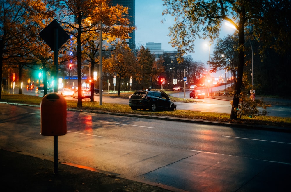 a street with cars on it and trees on the side