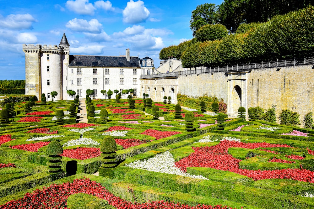 a garden in front of a large white building with Château de Villandry in the background