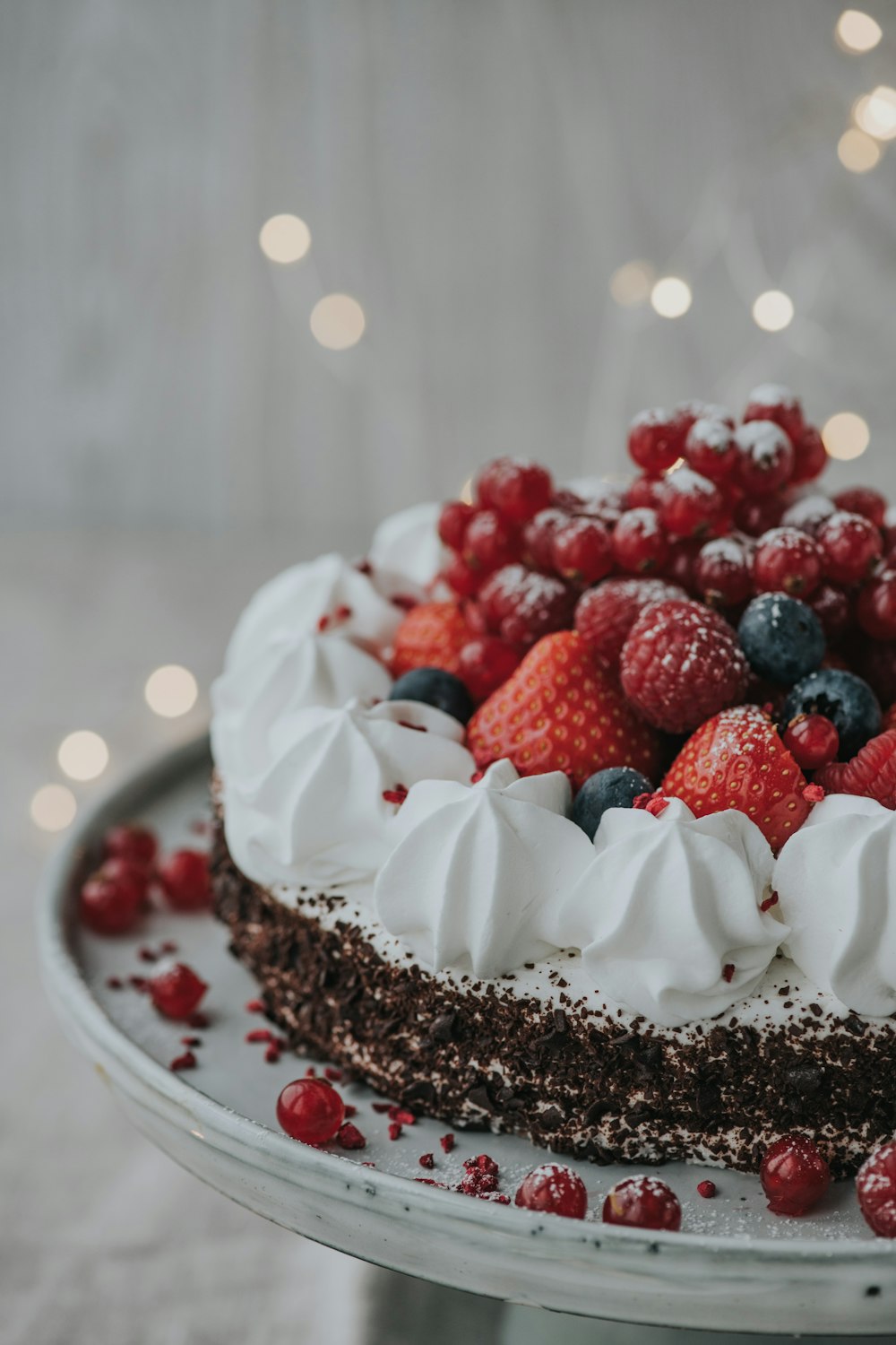 a cake with white frosting and berries on top