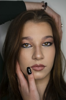 a woman with her hand on her face