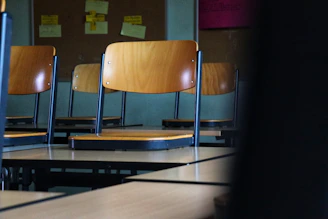 A cozy classroom setting with pastel walls, soft lighting, and students collaborating around a table