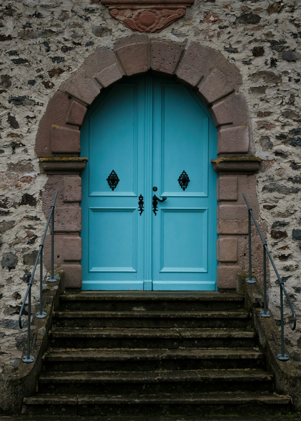 a blue door on a stone building
