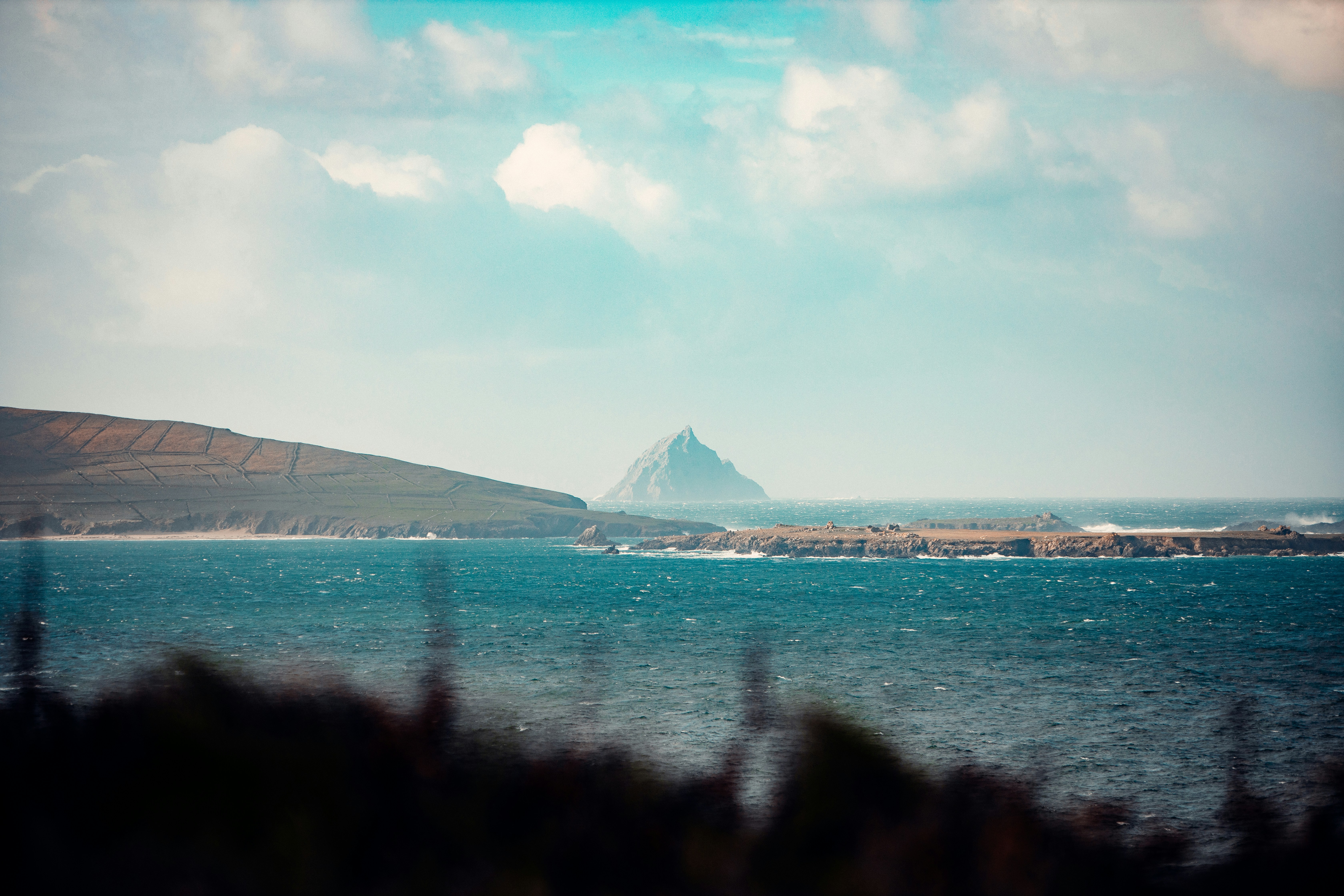 a body of water with a mountain in the distance
