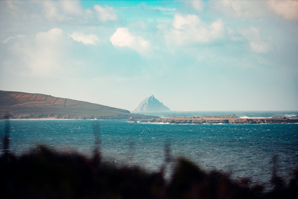 a body of water with a mountain in the distance