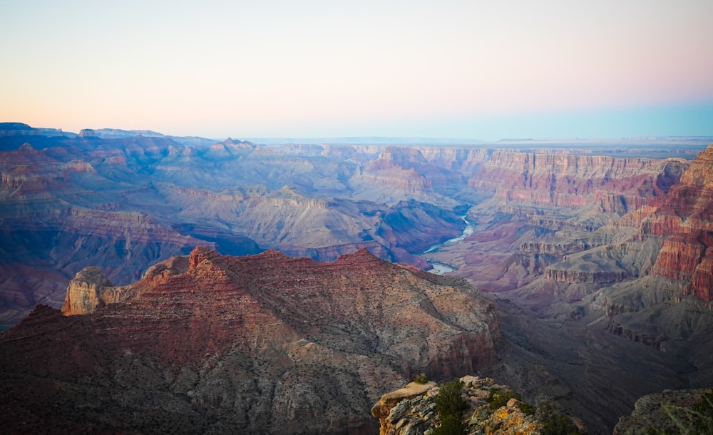 a canyon with a river running through it with Grand Canyon in the background