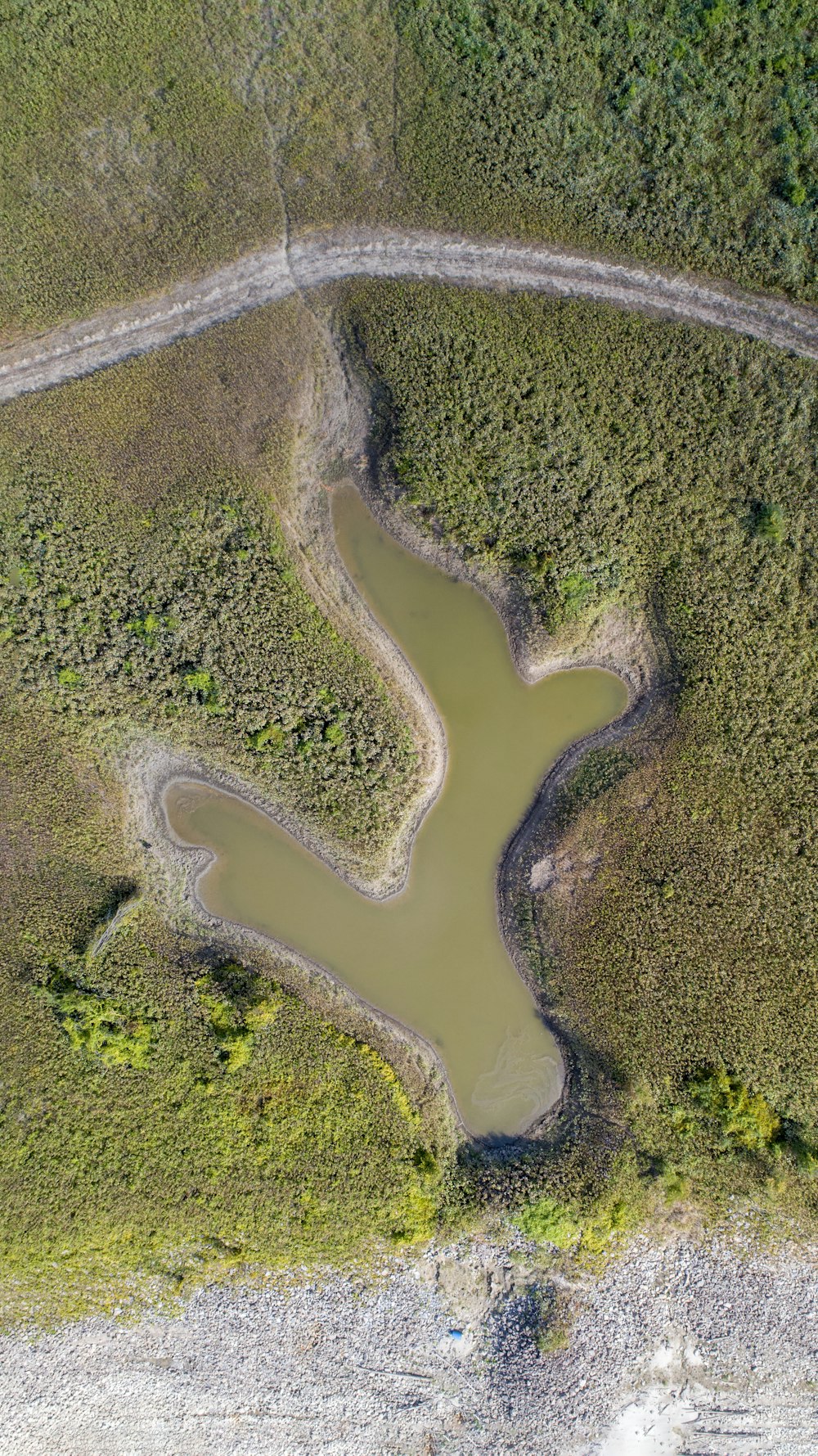 a winding road through a green landscape