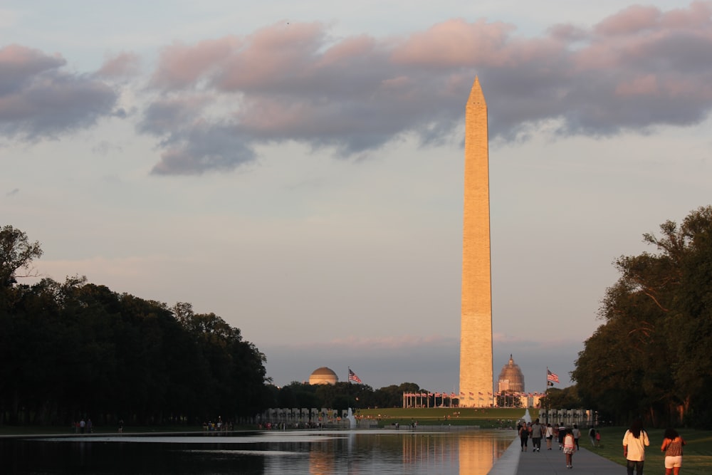 a tall monument with a body of water in front of it