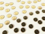Close-up of gold coins spilling over a dark glass coupon card with glowing edges.
