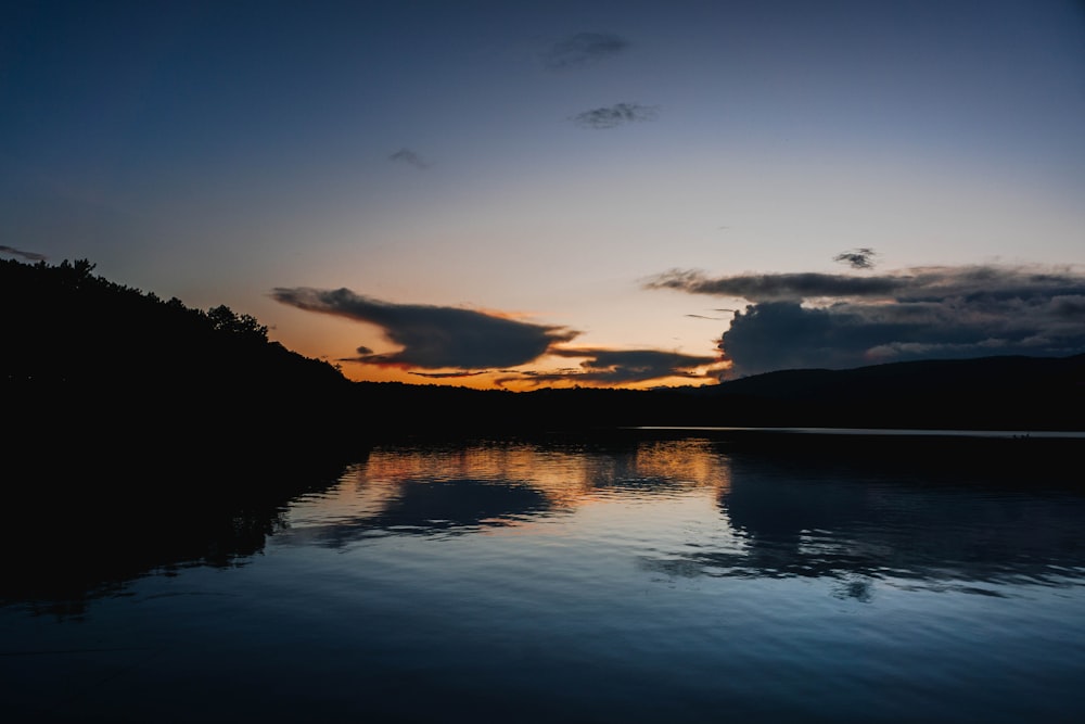 a body of water with hills in the background