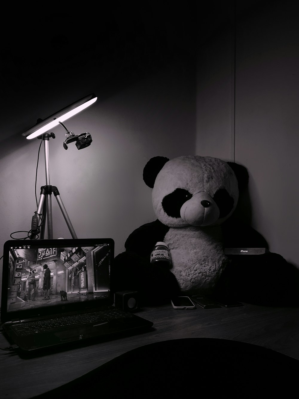 a stuffed panda bear sits on a desk