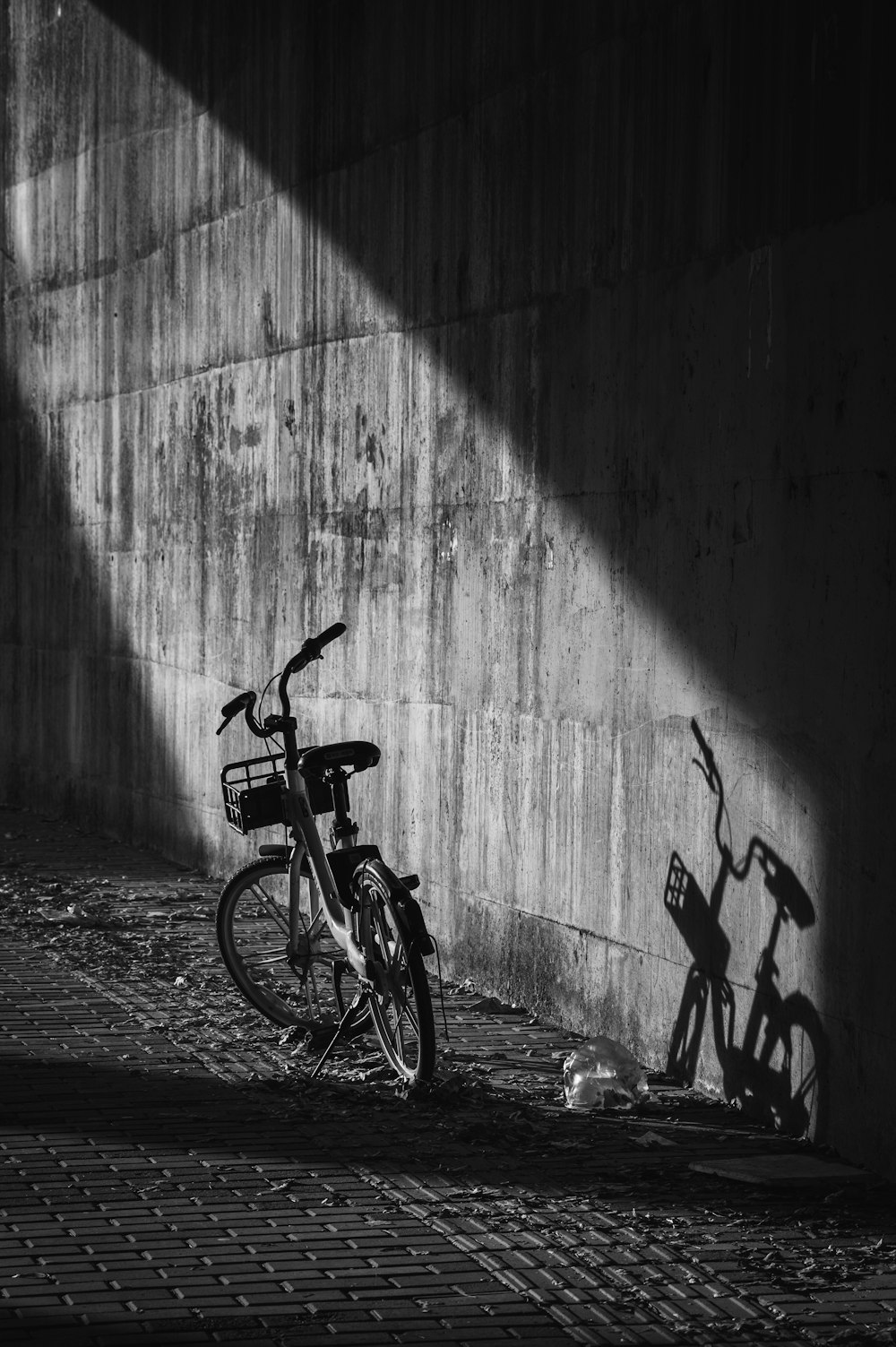 a bicycle parked next to a wall