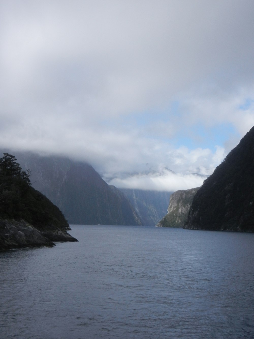 a body of water with mountains in the background