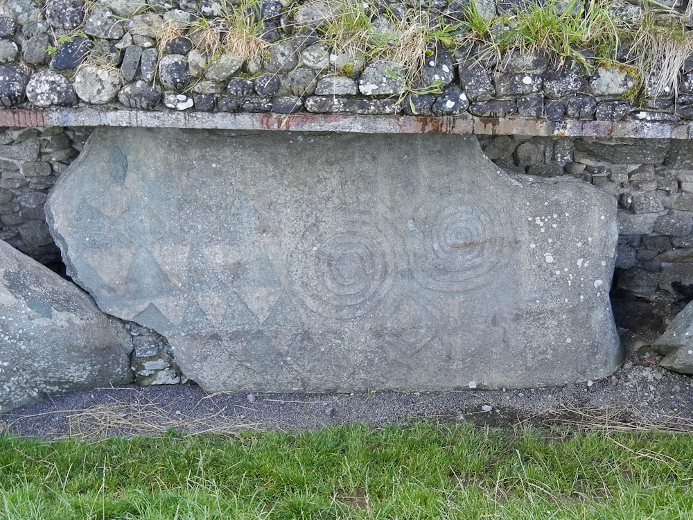 a stone wall with a carved face